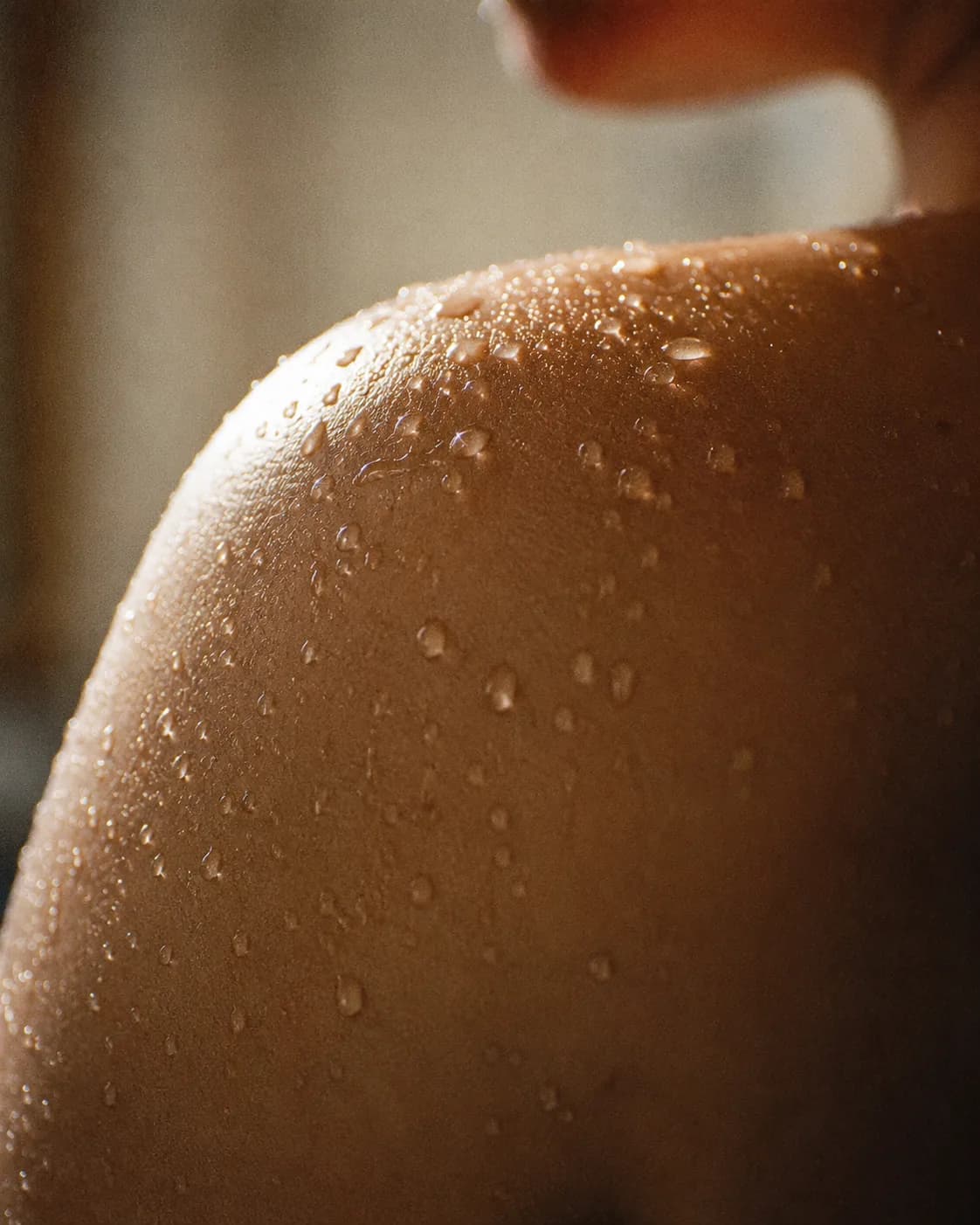 Soft, even editorial skin photography on a warm ground.